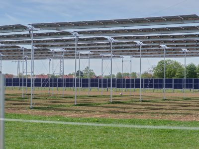 a row of metal poles in a field